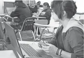  ??  ?? Veronica Holiday and her fellow Coding Club members are learning how to use codes like Python to program robots. Teacher Abigail Cooksey said the club is 90 percent female.