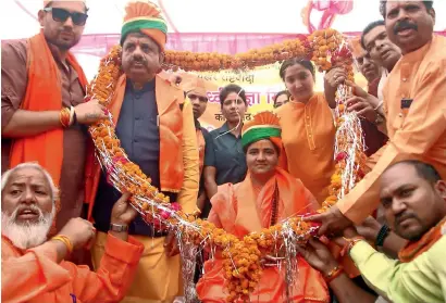  ?? — ANI ?? BJP candidate for the Bhopal Lok Sabha seat Sadhvi Pragya Singh Thakur being garlanded by her supporters during an election campaign ahead of the Lok Sabha polls in Bhopal on Tuesday.