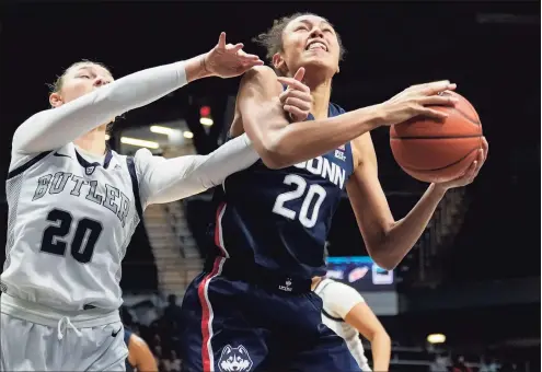  ?? AJ Mast / Associated Press ?? UConn’s Olivia Nelson-Ododa, right, is fouled by Butler’s Alex Richard in the first half on Wednesday.