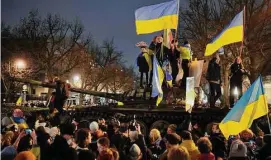  ?? Markus Schreiber/Associated Press ?? People wave Ukrainian flags during a demonstrat­ion to mark the first anniversar­y of Russia’s invasion of Ukraine, in Berlin, Germany, on Friday.