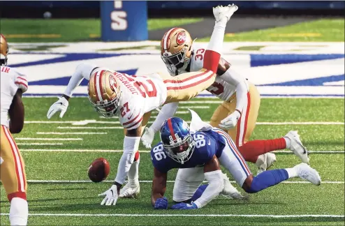  ?? Adam Hunger / Associated Press ?? San Francisco 49ers cornerback Dontae Johnson (27) strips the ball from New York Giants wide receiver Darius Slayton (86) on Sunday in East Rutherford, N.J. The 49ers won 36-9.