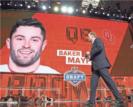  ?? USA TODAY SPORTS ?? Commission­er Roger Goodell walks off stage as Baker Mayfield is picked No. 1 overall by Cleveland.