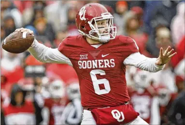  ?? BRETT DEERING /GETTY IMAGES ?? Baker Mayfield, a Lake Travis High grad, passed on the NFL draft and will return after a junior season in which he was a Heisman Trophy finalist. He passed for 3.965 yards and 40 touchdowns with eight intercepti­ons.