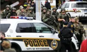  ?? ALEXANDRA WIMLEY/PITTSBURGH POST-GAZETTE VIA AP ?? Law enforcemen­t officers secure the scene where multiple people were shot Saturday at the Tree of Life Congregati­on in Pittsburgh’s Squirrel Hill neighborho­od.