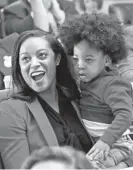  ?? STEVE HELBER/AP ?? Virginia Del. Jennifer Carroll Foy holds her son, Alex Foy, as she celebrates the passage of the Equal Rights Amendment in the House chambers at the Capitol in Richmond, Va., in January 2020.