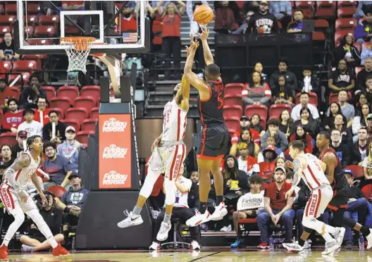  ?? ERIK VERDUZCO LAS VEGAS REVIEW-JOURNAL VIA AP ?? UNLV guard EJ Harkless (55) defends as San Diego State guard Lamont Butler (5) shoots during the first half on Saturday at the Thomas & Mack Center.