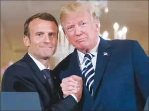  ?? AP PHOTO ?? President Donald Trump and French President Emmanuel Macron embrace at the conclusion of a news conference in the East Room of the White House in Washington, Tuesday.