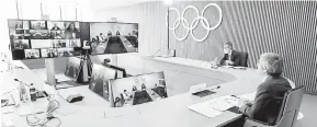  ?? — Gambar AFP ?? MESYUARAT: Gambar diambil dan diserahkan oleh IOC pada 24 Februari, menunjukka­n presiden Thomas Bach (Kanan) menghadiri mesyuarat melalui video Lembaga Eksekutif IOC di Lausanne.