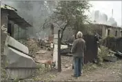  ?? Leo Correa Associated Press ?? IN POKROVSK, Ukraine, Oleksander Zaitsev looks at the house where his friend was found dead.