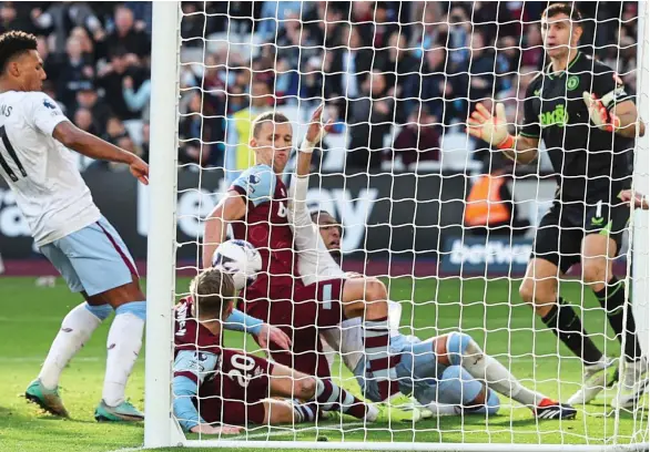  ?? ?? Controvers­y: West Ham’s Bowen and Soucek combine to force the ball over the line late on, but VAR intervened and the goal was eventually chalked off for handball