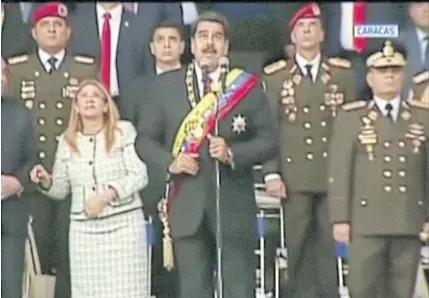  ??  ?? President Nicolas Maduro reacts to the presence of a drone during his speech on Saturday in this still photograph.