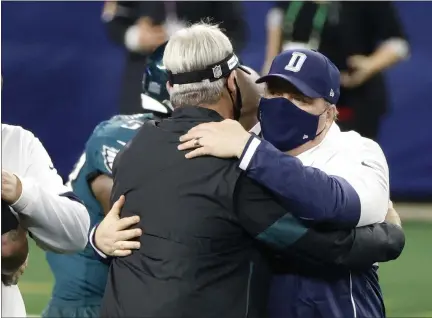  ?? MICHAEL AINSWORTH — THE ASSOCIATED PRESS ?? Eagles head coach Doug Pederson, left, and Dallas head coach Mike McCarthy non-distantly greet each other after the Cowboys ripped the Birds Sunday and eliminated them from playoff contention.