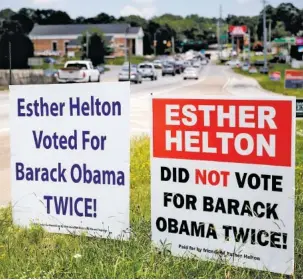  ?? STAFF PHOTO BY DOUG STRICKLAND ?? Two signs, the left labeled “Paid for by the Committee to Elect Jonathan Mason” and the right labeled “Paid for by Friends of Esther Helton,” are displayed along East Brainerd Road on Thursday.