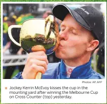  ?? Photos: AP, AFP ?? Jockey Kerrin McEvoy kisses the cup in the mounting yard after winning the Melbourne Cup on Cross Counter (top) yesterday.