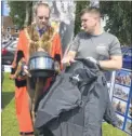  ?? FM4813241 ?? Mayor of Tenterden Cllr Justin Nelson checks out a Kevlar bomb suit with Royal Engineer Sapper John Wright