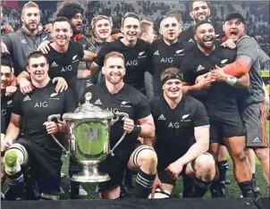  ?? MARTY MELVILLE/AFP ?? New Zealand captain Kieran Read holds the Bledisloe Cup after victory in the Test against Australia at Forsyth Barr Stadium in Dunedin on Saturday.