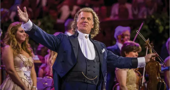  ?? Marcel van Hoorn ?? Violinist Andre Rieu has sold more than 40 million albums; below, his style of classical music celebrates the dance of the waltz with extravagan­ce