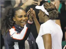  ?? Chuck Burton / Associated Press ?? Venus Williams, right, is congratula­ted by U.S. teammate and sister Serena after defeating the Netherland­s’ Arantxa Rus.