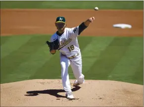  ?? TONY AVELAR — THE ASSOCIATED PRESS ?? The A’s Cole Irvin pitched six shutout innings against the Tigers, allowing four hits and striking out six.