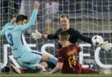 ?? GREGORIO BORGIA — THE ASSOCIATED PRESS ?? Barcelona goalkeeper Marc-Andre ter Stegen, rear, defends as Roma’s Patrik Schick, foreground right, tries to score during the Champions League quarterfin­al second leg match at Rome’s Olympic Stadium on Tuesday. At left is Barcelona’s Gerard Pique.