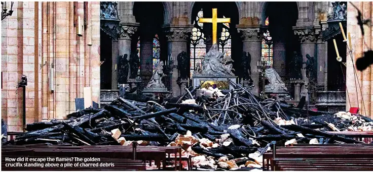  ??  ?? How did it escape the flames? The golden crucifix standing above a pile of charred debris