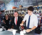  ?? THE CANADIAN PRESS/FILES ?? Justin Trudeau with Pierre Breton during a campaign stop at a coffee shop in Granby, Que., in October 2015.