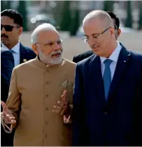  ?? AFP ?? Narendra Modi walks with Palestinia­n Prime Minister Rami Hamdallah upon his arrival in Ramallah on Saturday.—