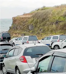  ?? ?? Dozens of carloads and crowds of people have been gathering pāua along the Taranaki coast in recent weeks.