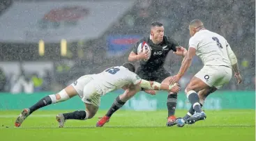  ?? /Phil Walter/Getty Images ?? Excellent performanc­e: Ryan Crotty takes on England’s Henry Slade and Kyle Sinckler on Saturday. Crotty came on for the injured Sonny Bill Williams and put in an excellent performanc­e.