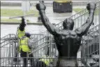  ?? MATT ROURKE - THE ASSOCIATED PRESS ?? Workers make preparatio­ns ahead of the 2017 NFL football draft in view of the Rocky statue in Philadelph­ia, Tuesday.