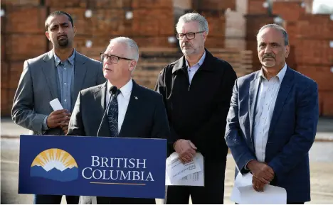  ?? CITIZEN PHOTO BY BRENT BRAATEN ?? Minister of Forests Doug Donaldson, at podium, and Parliament­ary Secretary Ravi Kahlon, Mayor Lyn Hall and Labour Minster Harry Baines make an announceme­nt about helping B.C.’s interior forestry workers affected by mill closures in Prince George on Tuesday.