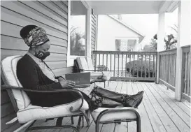  ?? BARBARA HADDOCK TAYLOR/BALTIMORE SUN ?? Tikvah Nadia Womack reads her family’s Haggadah, which tells the story of Passover, on her front porch on Wednesday.