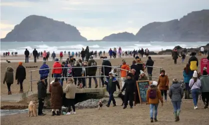  ??  ?? A crowded Perranport­h Beach, south of Newquay, on New Year’s Day. Photograph: Tom Nicholson/Reuters