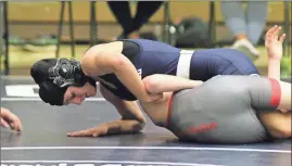  ?? / Scott Herpst ?? Gordon Lee 106-pounder Mckaden Martin rolls over her Mt. Zion opponent during last week’s dual. Martin got the pin to help the Trojans get the victory.