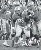  ?? JOSHUA A. BICKEL/COLUMBUS DISPATCH ?? Ohio State defensive tackle Tyleik Williams celebrates after sacking Akron quarterbac­k DJ Irons.