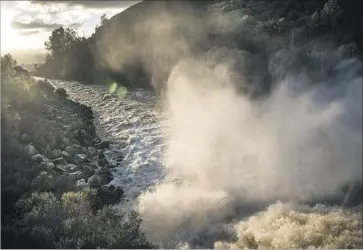  ?? Photograph­s by David Butow ?? THE TROUBLE began Saturday, when Anderson Reservoir reached its capacity and water began f lowing down its spillway toward San Jose. Another round of rain exacerbate­d the situation Sunday and Monday.