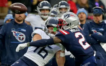  ?? Matt Stone, Boston Herald ?? The Patriots’ Jalen Mills hits the ball out of the hands of Titans wide receiver Cody Hollister during the third quarter Sunday in Foxboro, Mass.