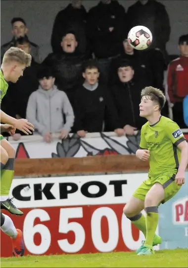  ??  ?? Lloyd Buckley out-manoeuvres Benny Igiehon to head clear for Drogheda United,watched by Conor Kane, during Saturday evening’s SSE Airtricity League Premier Division clash at The Showground­s.