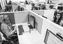  ??  ?? An employee speaks to a customer at a call centre in Bengaluru