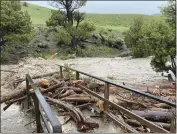  ?? ?? In this photo provided by the National Park Service, is a washed out bridge from flooding at Rescue Creek in Yellowston­e National Park, Mont., on Monday.