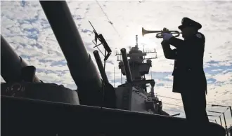  ?? MATT ROURKE/ AP ?? Greg Murphy plays the Navy Hymn last year during a ceremony commemorat­ing the 75th anniversar­y of the attack on Pearl Harbor, on board the battleship New Jersey Museum and Memorial in Camden, N. J.