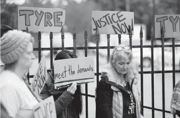  ?? GERALD HERBERT AP ?? A group of demonstrat­ors protest outside a police precinct Sunday in response to the death of Tyre Nichols, who died after being beaten by five police officers after a traffic stop in Memphis, Tenn., earlier this month.