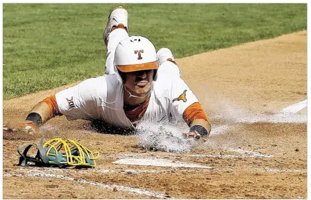  ?? SUE OGROCKI / ASSOCIATED PRESS ?? Texas’ Tres Barrera scores on Collin Shaw’s squeeze bunt during the second inning Thursday. Barrera later hit a two-out RBI single in the bottom of the ninth after Baylor had tied it with a three-run homer in the top half. The Horns improved to 2- 0 in...