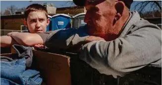  ??  ?? BELOw: Gabe Richardson, left, helped Leroy Culley fill up his truck with donated supplies after the latter lost his house and most of his possession­s in the flood.