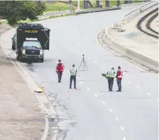  ?? GAVIN YOUNG ?? Police investigat­e the scene where a pedestrian was struck on eastbound Memorial Drive on Sunday.