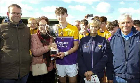  ??  ?? The new Hughie Foley Memorial Cup is presented to Emmett Nolan, the Faythe Harriers captain, by Anne Foley, with Alan Aherne (Group Sports Editor, People Newspapers) and Coiste na nOg officers Angela McCormack and Bobby Goff looking on.