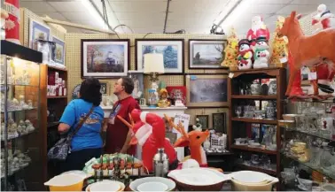  ??  ?? Belinda and Vincent Sedman look at Hallmark Christmas gifts at Yesteryear Antiques &amp; Memories. Last year the two stumbled upon the Christmas in July sale and decided to check out what items were available during the sale this year.