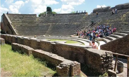  ?? RICK STEVES ?? The show still goes on in ancient Ostia’s theater. One of the oldest brick theaters anywhere, it’s still used for concerts today.