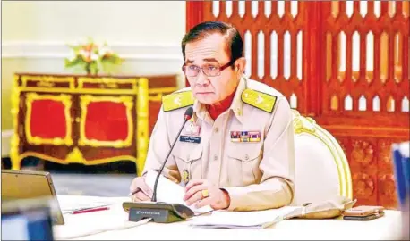  ??  ?? Thai Prime Minister Prayut Chan-O-Cha presides over a meeting at the Government House in Bangkok. Thailand’s junta chief on Monday dismissed rumours of an impending coup as ‘fake news’, as speculatio­n ricocheted across a kingdom unsettled by the ill-fated political union between a princess and a party allied to the powerful Shinawatra clan.