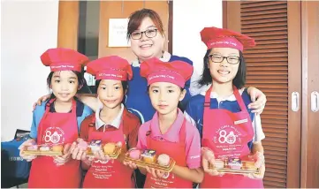  ??  ?? Chow poses with some cadets and their creations.